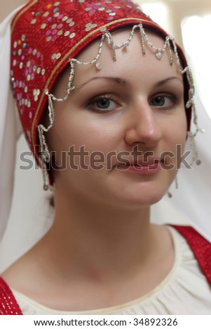The young woman poses in old russian hat