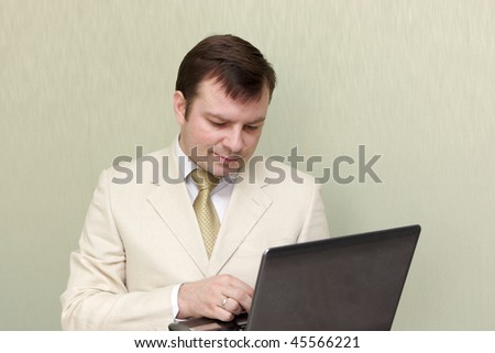 The man writing a letter by laptop
