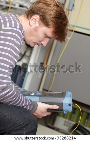 The technician analysis measuring results at the server room