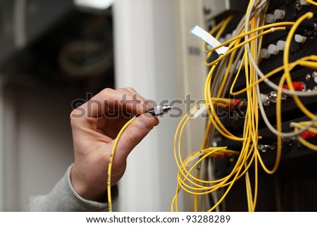 The technician connecting fiber optic on the telecom site