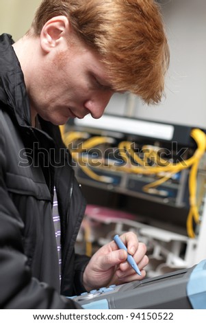 A serious technician working at telecom site