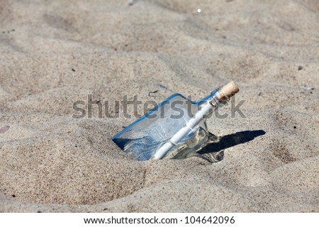 Message in a bottle stuck in sand on the beach of the Baltic Sea