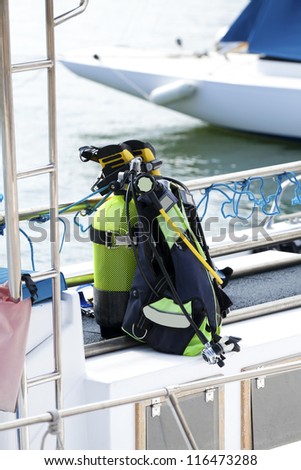 Diving equipment with oxygen tank, diving goggles and snorkel on a boat