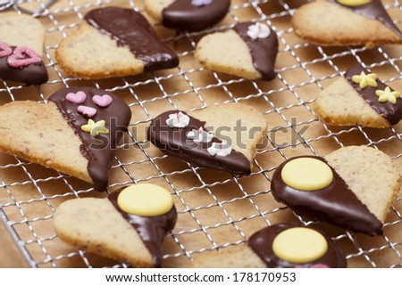 Ready-baked cookies in heart shape with decor sugar on a cake rack