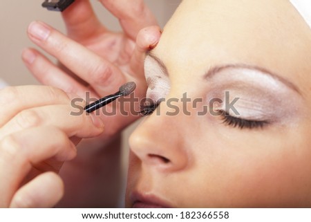 Beautiful young face with a modern make-up at her beautician
