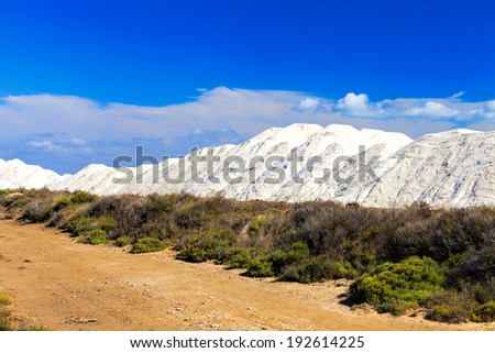 View of many salt mountains under blue skies at a Saline Gruissan in the South of France