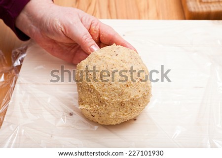 Ready with hands shaped dough ball on plastic wrap