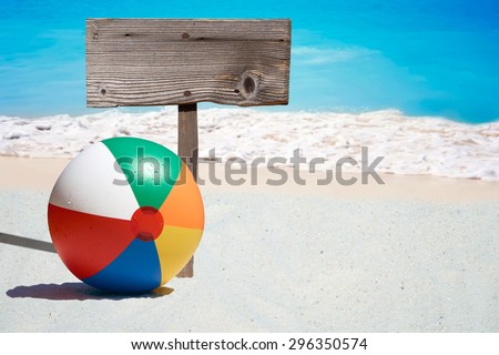 Colorful Beach Ball and a wooden Signboard on the Beach