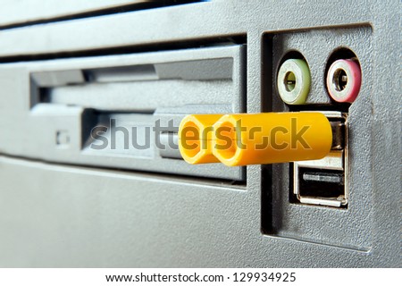 face of computer concept. eyes - headphones and microphone plugs, nose - pen drive, mount - usb port