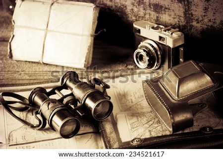 vintage  travel memories concept. Old camera, binoculars, letters and map holder with map with vignette