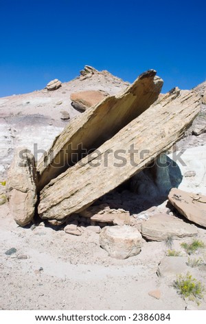 Fallen rock perched at an angle in a badlands area on the Tabguache Trail near Grand Junction, Colorado