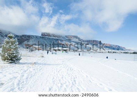 Saturday in Wingate park, Grand Junction, Colorado with a walker and families playing in the snow