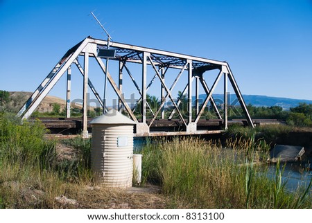 Stream flow meter and railroad bridge near Delta, Colorado in early summer