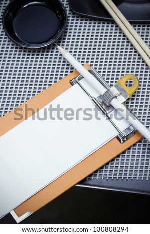 blank notepad and pencil for order from clients in a restaurant