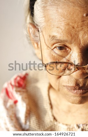 Close up portrait of a sad older woman.