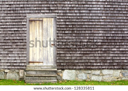rustic door on shake sided house with stone foundation