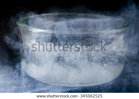 Liquid nitrogen boiling in a clear glass bowl at room temperature