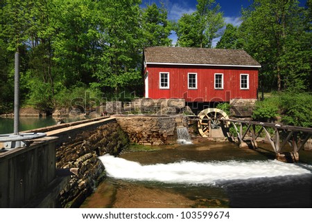Picture, general view of old (historical building) Living Museum, Sawmill on Beaverdams Creek Ontario and small pond with pond wall and Water Wheel which was powered the water sawmill.