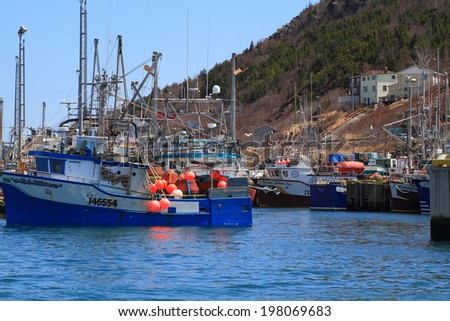ST. JOHN\'S HARBOR CANADA MARCH 17: St. John\'s Harbor, Newfoundland, Canada on March 17, 2014. Town of St. John\'s prepares for Celebration of Victoria Day Long Weekend all fishing boats are moored in harbor