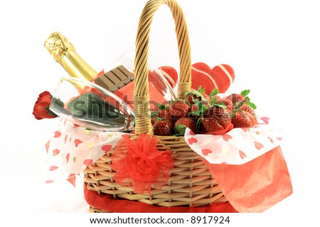 Valentines Day Basket 1. Chocolate, Strawberries, Champagne, Rose and Lollipops in decorated basket typical attributes for Valentines Day. Front view.