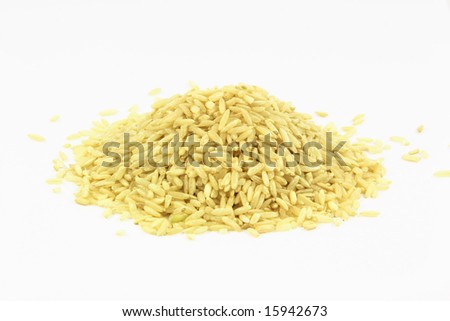 Brown rice. A pile of brown rice over white background.