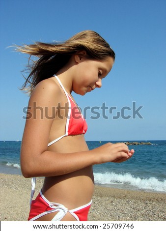 stock photo young girl the teenager on a sea beach collects cockleshells