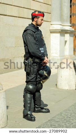 BARCELONA - MARCH 19 : A local police guards house of government during students demonstration against a new education system on March 19, 2009 in Barcelona, Spain. Two dozen students injured and more than 30 officers hurt.