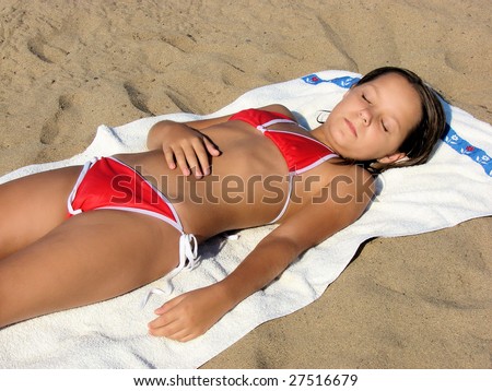 stock photo young european girl teenager laying and sunbathing on a beach 