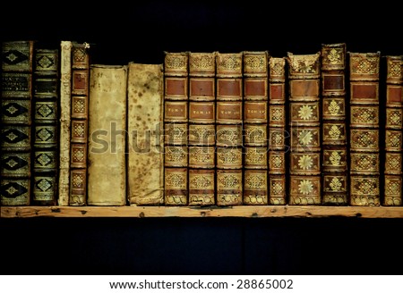 old books on an archival shelf of library of storehouse on  isolated black background