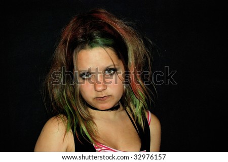 Punk emo girl, young adult with black red hair, sitting at a