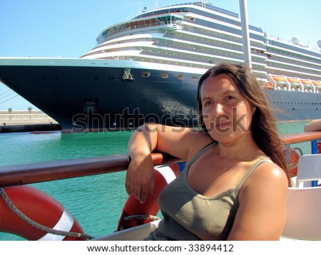 woman floating by the excursion ship in port of Barcelona, Spain