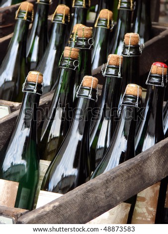glass bottles with stoppers in a wooden box