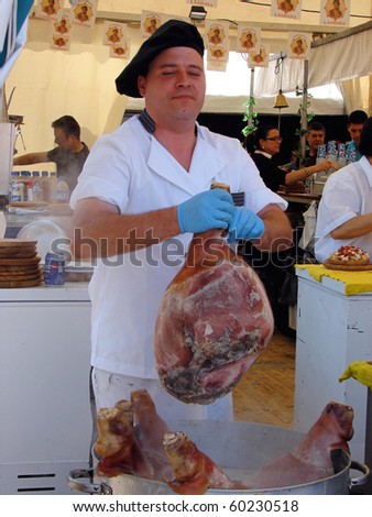 BARCELONA - APRIL 30: Cook from Valencia cuts a boiled pork at the April fair on April 30, 2009 in Barcelona, Spain.