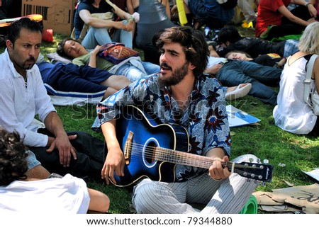 BARCELONA, SPAIN-JUNE 14, the Student sings a protest song in park on June 14, 2011 in Barcelona, Spain. students against reduction of social programs