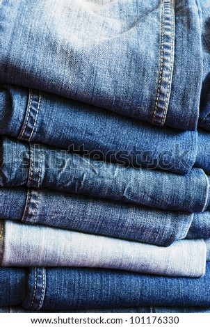 Pile of trousers made of blue denim jeans