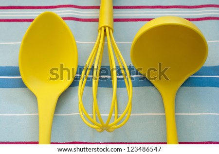 Set of kitchen tools on the blue striped tablecloth.