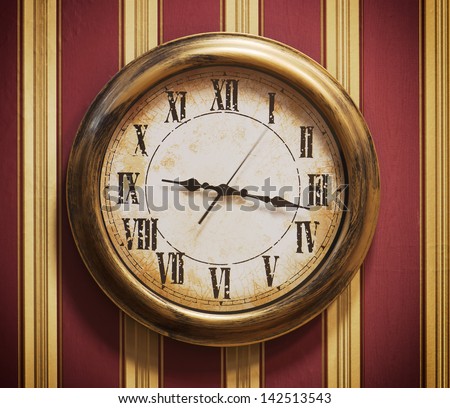 Retro wall clock with striped wallpaper.