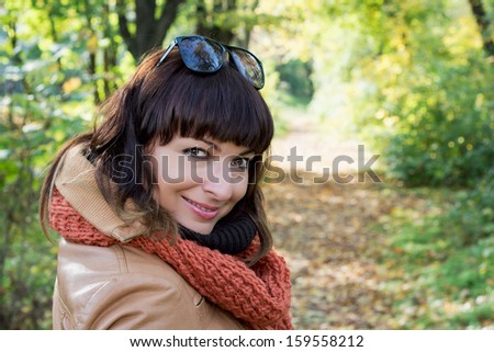 Beautiful caucasian woman posing in autumn park.