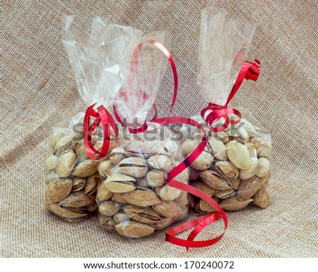 Pistachios packed in mini bags with red bows.