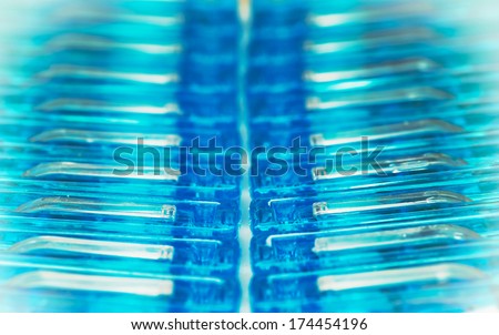 Background of blue clothes pegs.