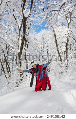 Young positive woman posing in snowy landscape. Winter theme.