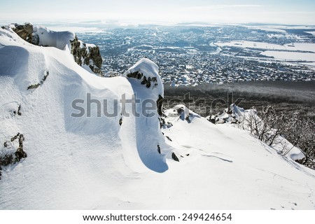 Snowy rocks with Nitra city in the background. Winter tourism.