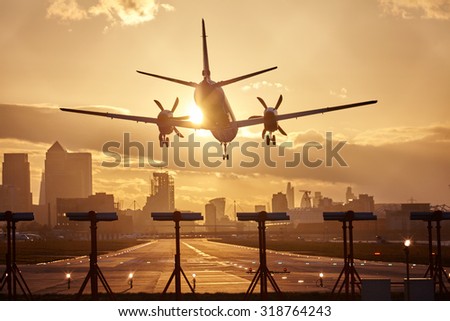 Airplane landing in sunset.