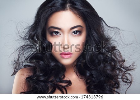 Young And Beautiful Asian Woman With Curly Hair