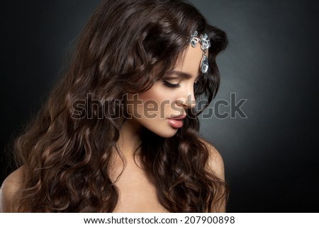 Beautiful brunette model with long curly brown hair. Gems.