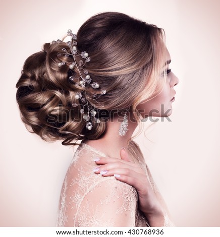 Beautiful bride with fashion wedding hairstyle - on beige background.Closeup portrait of young gorgeous bride. Wedding. Studio shot.