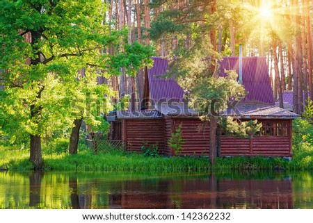 Wooden house in forest at the lake