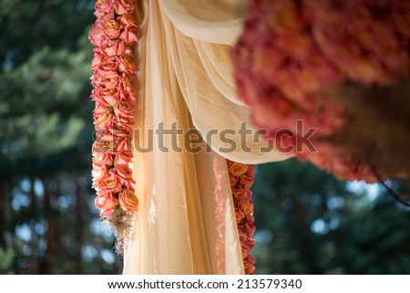 Very beautiful ornament made of roses hanging down on background of forest