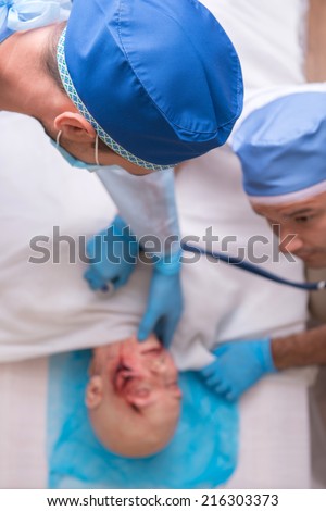 Selective focus on the head of the doctor examined the victim of the car accident lying on background. Top view