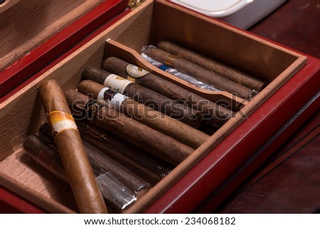 An expensive wooden box with great Cuban cigars. Close up